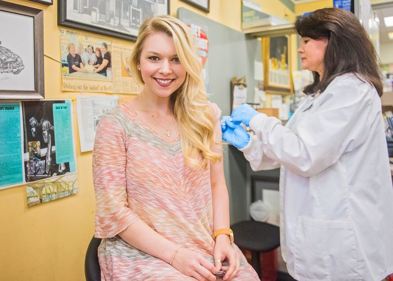 A pharmacist administering an immunization